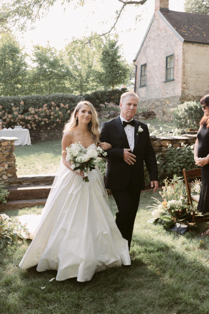 Dad walks the bride down the aisle in intimate garden wedding ceremony
