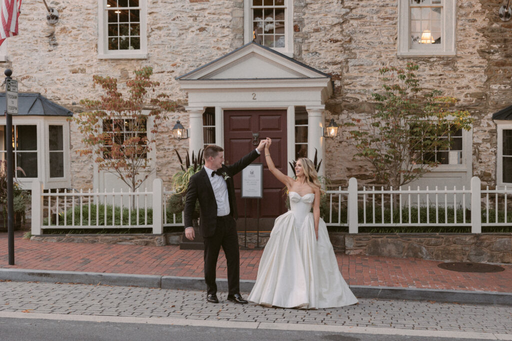 Bride and groom pose outside the Red Fox Inn and Tavern during sunset