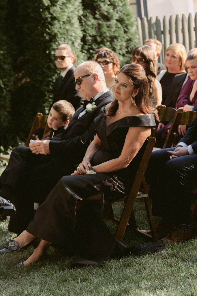 Mother of the bride shows a teary eyed smile as as she watches her daughter get married